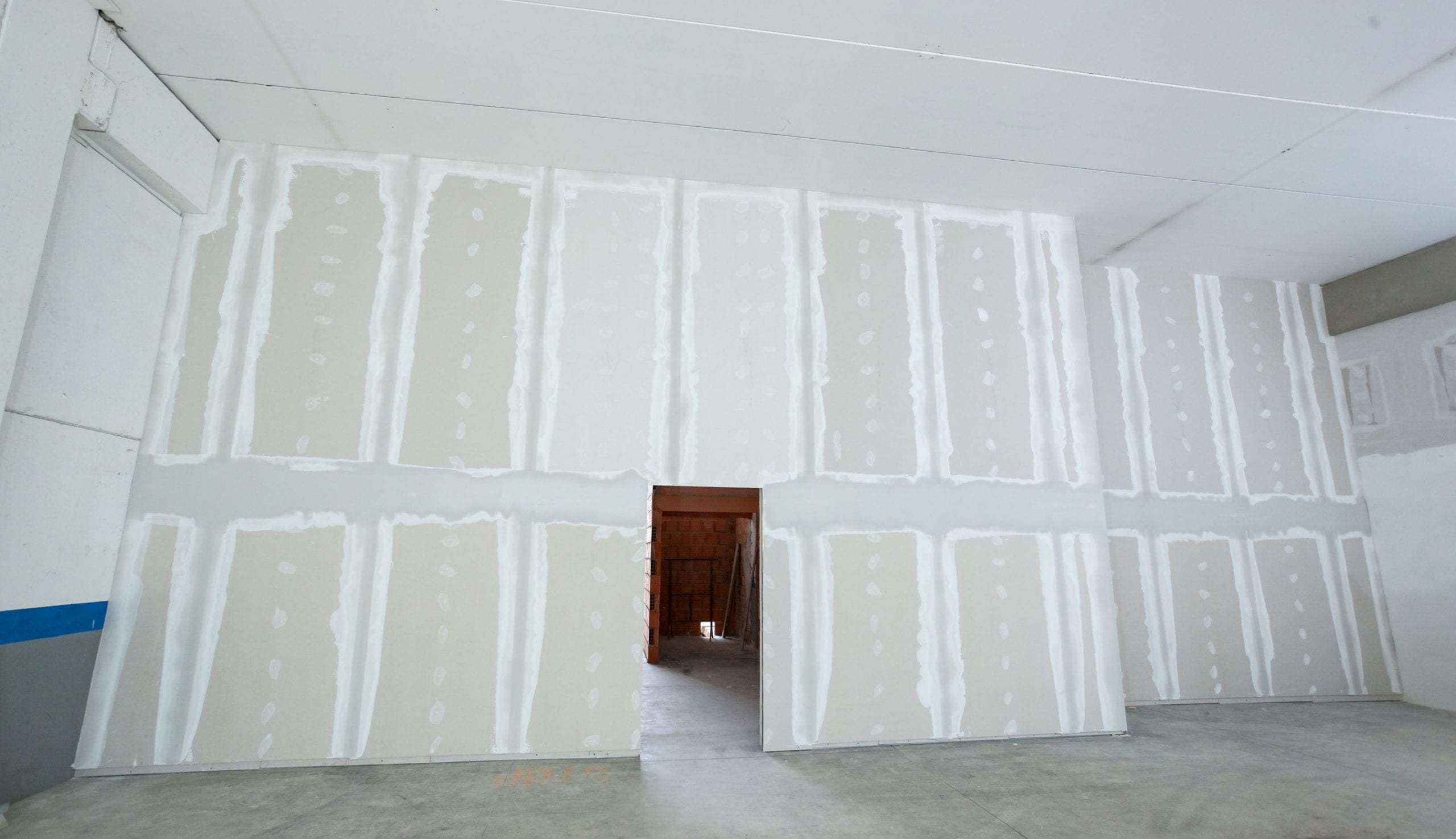 Wall made from plasterboard drywall and prepared to painting in industrial construction.