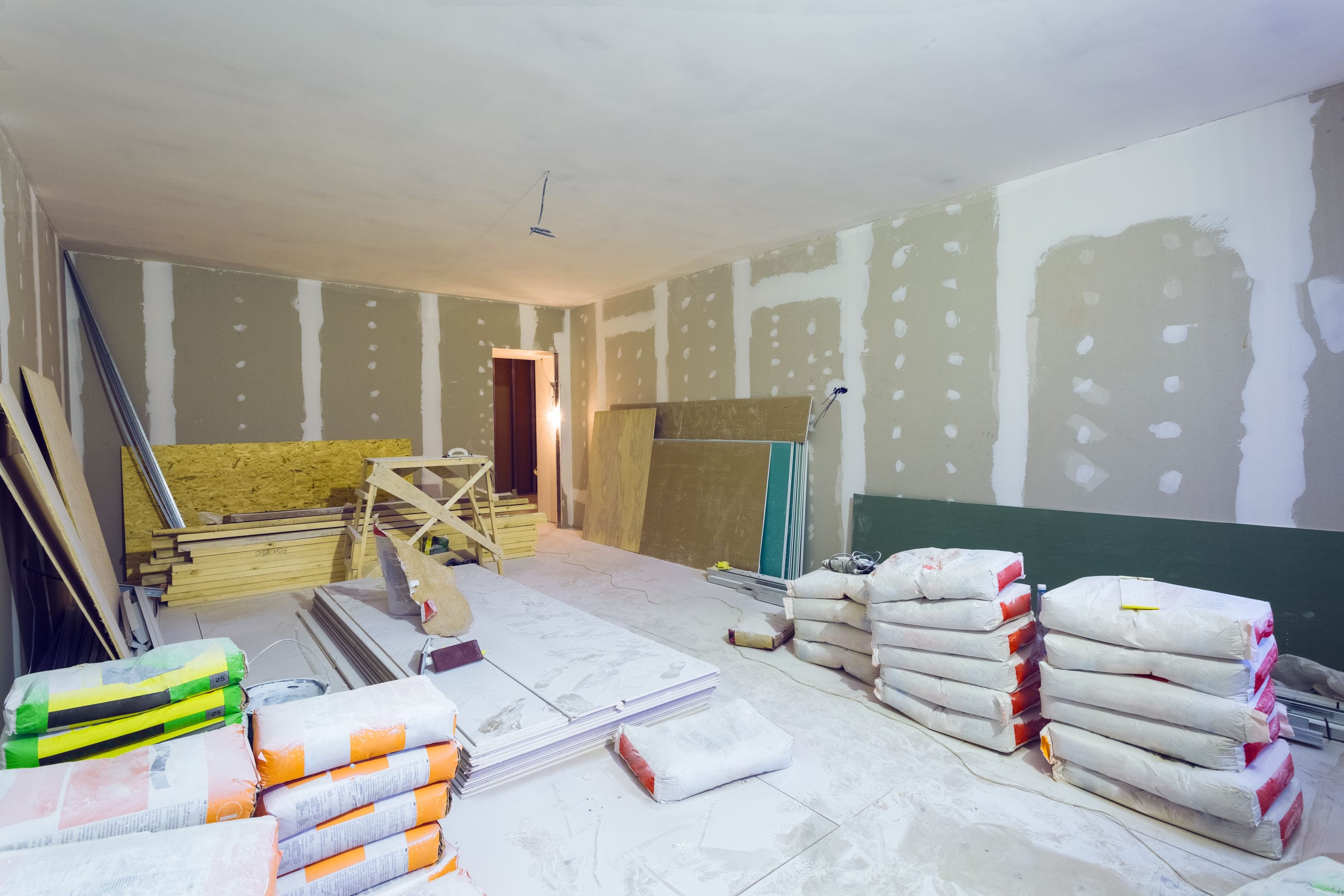 Materials for constraction (putty packs, sheets of plasterboard or drywall)  in apartment is under construction, remodeling, renovation, extension, restoration and reconstruction.